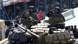 Iranian soldiers salute from a T-72 tank during the annual military parade marking the anniversary of Iran's war with Iraq (1980-88) in Tehran, on September 22, 2014. Iran is a cornerstone of stability in the Middle East in the face of the "terrorists" rocking the region, President Hassan Rouhani said before leaving for the United Nations. AFP PHOTO/ BEHROUZ MEHRI        (Photo credit should read BEHROUZ MEHRI/AFP/Getty Images)