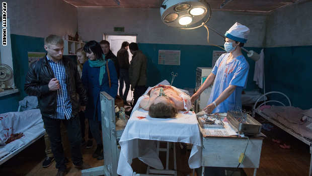 People inspect an installation representing an operating room at the exhibition "Material Evidence. Donbass. 365 Days in Moscow on April 13, 2015. The exhibition focuses on the armed conflict in eastern Ukraine. AFP PHOTO / ALEXANDER UTKIN (Photo credit should read ALEXANDER UTKIN/AFP/Getty Images)
