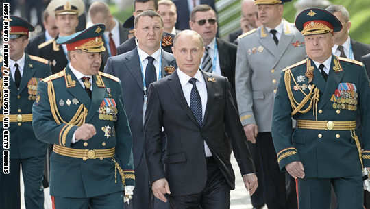 MOSCOW, RUSSIA - MAY 9:  In this handout image supplied by Host photo agency / RIA Novosti, Russian President Vladimir Putin, center, Russian Defense Minister and Army General Sergei Shoigu, left, and Victory Parade Commander and Commander-in-Chief of the Russian Ground Forces, Colonel-General Oleg Salyukov, right, before the flower-laying ceremony at the Tomb of the Unknown Soldier  on the day of a military parade to mark the 70th anniversary of Victory in the 1941-1945 Great Patriotic War, May 9, 2015 in Moscow, Russia. The Victory Day parade commemorates the end of World War II in Europe. (Photo by Host photo agency / RIA Novosti via Getty Images)