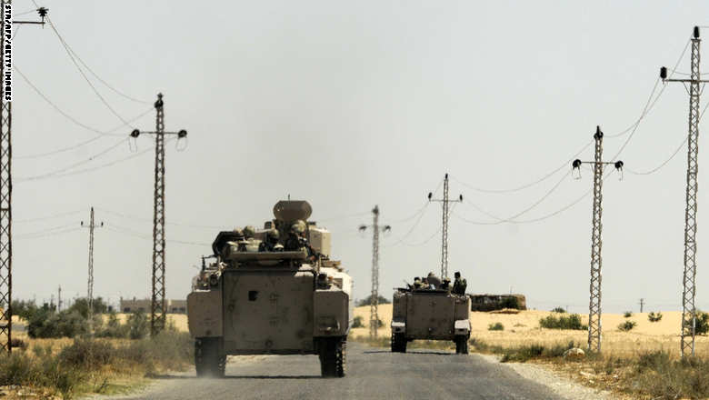 Egyptian soldiers and a military helicopter are deployed in the area of the Rafah Crossing border between Egypt and the Gaza Strip on May 21, 2013 as Egypt intensified efforts to secure the release of seven security personnel captured in the Sinai. Tensions remained high in the peninsula after two attacks by gunmen on or near police camps, and the kidnap last week of three policemen and four soldiers. AFP PHOTO / STR (Photo credit should read STR/AFP/Getty Images)