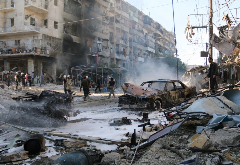 Syrians gather at the site of reported air strikes by government forces on May 1, 2014 in the Halak neighbourhood in northeastern Aleppo. According to the Syrian Observatory for Human Rights, at least 33 civilians were killed in the attack.  AFP PHOTO / AMC / ZEIN AL-RIFAI