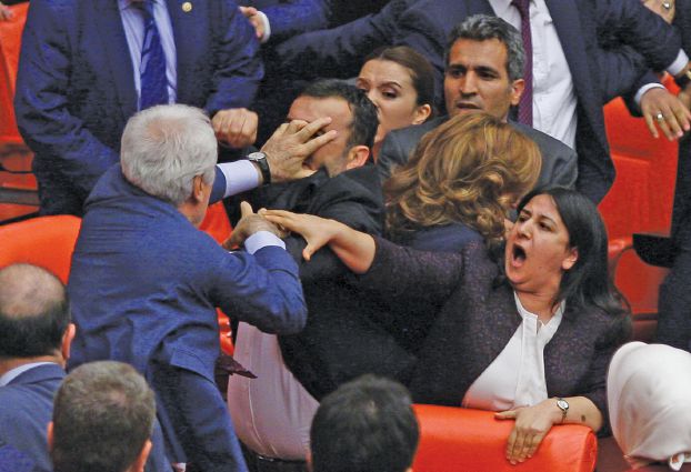Ruling AK Party and pro-Kurdish Peoples' Democratic Party (HDP) lawmakers scuffle during a debate at the Parliament in Ankara, Turkey late April 27, 2016.  REUTERS/Stringer   EDITORIAL USE ONLY. NO RESALES. NO ARCHIVE
