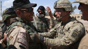 TAJI, IRAQ - APRIL 12:  A U.S. Army trainer (R), speaks with an Iraqi Army recruit at a military base on April 12, 2015 in Taji, Iraq. U.S. forces, currently operating in 5 large bases throught Iraq, are training thousands of Iraqi Army combat troops, trying to rebuild a force they had origninally trained before the U.S. withdrawal from Iraq in 2010. Members of the U.S. Army's 5-73 CAV, 3BCT, 82nd Airborne Division are teaching members of the newly-formed 15th Division of the Iraqi Army, as the Iraqi government launches offensives to try to recover territory lost to ISIS last year.  (Photo by John Moore/Getty Images)