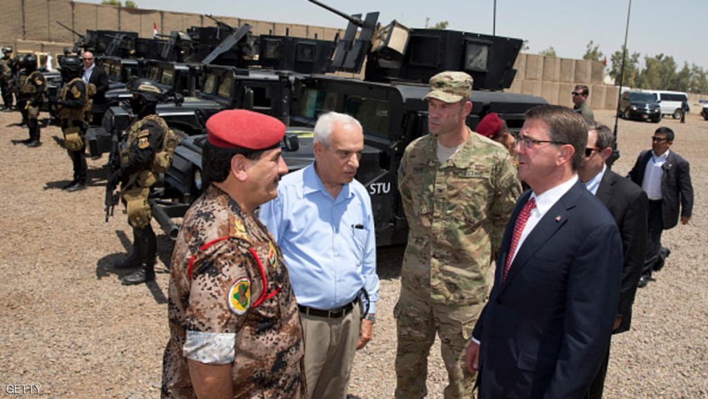 BAGHDAD, IRAQ - JULY 23: U.S. Defense Secretary Ash Carter (R) stands with Col. Otto Liller, commander,1st Special Forces Group (Airborne), (2nd R) as he is greeted by Iraqi Major General Falah al Mohamedawi (L) to observe Iraqi Counter Terrorism Service forces participating in a training exercise at the Iraqi Counter Terrorism Service Academy on the Baghdad Airport Complex July 23, 2015 in Baghdad, Iraq. Carter is on a week long tour of the Middle East focused on reassuring allies about Iran and assessing progress in the coalition air campaign against the Islamic State in Syria and Iraq. (Photo by Carolyn Kaster-Pool/Getty Images)